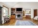 A spacious living room showcasing a fireplace, hardwood floors, and natural light at 11471 Clarkston Rd, Zionsville, IN 46077
