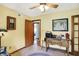 Comfortable office features neutral walls and floors, a desk, and French doors at 11471 Clarkston Rd, Zionsville, IN 46077