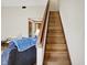 Wooden staircase leading to the upper level, complemented by neutral walls and natural lighting at 11471 Clarkston Rd, Zionsville, IN 46077