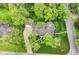 Stunning aerial view of a home with lush landscaping, large lawn and an outdoor dining area for entertaining at 11550 Clarkston Rd, Zionsville, IN 46077