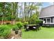 Enjoy the backyard featuring an outdoor dining set, artificial turf, and lush landscaping at 11550 Clarkston Rd, Zionsville, IN 46077
