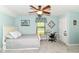 Comfortable bedroom features a light blue color scheme, ceiling fan, and a quaint sewing station at 11550 Clarkston Rd, Zionsville, IN 46077