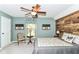 Cozy bedroom featuring a ceiling fan, painted walls, wood accent wall, and comfortable decor at 11550 Clarkston Rd, Zionsville, IN 46077