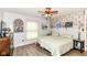Inviting bedroom with exposed brick, ceiling fan, and two comfortable beds at 11550 Clarkston Rd, Zionsville, IN 46077
