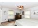 Bright bedroom with a ceiling fan, two windows, and a dark wood dresser at 11550 Clarkston Rd, Zionsville, IN 46077