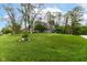 Inviting two-story home with gray siding, dormer windows, mature landscaping and a well-manicured lawn at 11550 Clarkston Rd, Zionsville, IN 46077