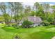 Beautifully landscaped lawn and charming gray home, complete with mature trees and inviting curb appeal at 11550 Clarkston Rd, Zionsville, IN 46077