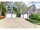 A large detached garage is located near the home and features multiple garage doors and a private gated area at 11550 Clarkston Rd, Zionsville, IN 46077