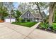 Charming home boasts a well-manicured lawn, landscaped garden beds, and a large driveway leading to a detached garage at 11550 Clarkston Rd, Zionsville, IN 46077