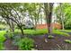 Charming front yard featuring lush landscaping, mature trees, and a well-maintained lawn at 11550 Clarkston Rd, Zionsville, IN 46077