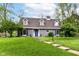 Charming gray home with a lush front lawn, beautiful landscaping and inviting blue front door at 11550 Clarkston Rd, Zionsville, IN 46077