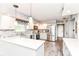 Bright kitchen with quartz countertops, white cabinets, stainless steel appliances, and wood floors at 11550 Clarkston Rd, Zionsville, IN 46077