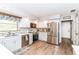 Well-lit kitchen features stainless steel appliances, wood floors, and tiled backsplash at 11550 Clarkston Rd, Zionsville, IN 46077