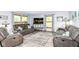 Cozy living room with gray sofas, area rug, large windows, and a TV at 11550 Clarkston Rd, Zionsville, IN 46077