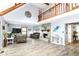 Spacious living room with vaulted ceiling, stone fireplace, and wood-look floors at 11550 Clarkston Rd, Zionsville, IN 46077