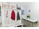 Mudroom features bench and coat rack with shelf space and marble-look countertops at 11550 Clarkston Rd, Zionsville, IN 46077