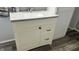 Bathroom vanity with a white countertop and modern hardware and fixtures. Wood-look flooring visible at 1202 S Ribble Ave, Muncie, IN 47302