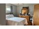 This cozy bedroom features a natural wood dresser, ceiling fan, and a window letting in natural light at 1202 S Ribble Ave, Muncie, IN 47302