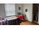 Cozy bedroom with hardwood floors, bright windows, and adjacent bathroom at 1202 S Ribble Ave, Muncie, IN 47302