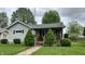 Charming single-story home with a cozy front porch, well-maintained lawn, and mature landscaping at 1202 S Ribble Ave, Muncie, IN 47302
