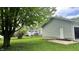 A spacious backyard with a detached garage and a glimpse of the home's exterior at 1202 S Ribble Ave, Muncie, IN 47302