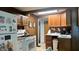 Functional kitchen with white appliances, wood cabinets, and a view of the dining area at 1202 S Ribble Ave, Muncie, IN 47302
