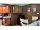 View of the kitchen area with wooden cabinets and a view of the breakfast nook area at 1202 S Ribble Ave, Muncie, IN 47302