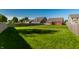 Spacious backyard features lush green grass, surrounded by a wooden fence at 1221 Danielle Rd, Lebanon, IN 46052
