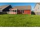 A spacious backyard with lush grass and a cozy screened-in patio at 1221 Danielle Rd, Lebanon, IN 46052
