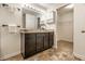 Bathroom with dark vanity, bright lighting, and closet at 1221 Danielle Rd, Lebanon, IN 46052