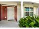 Inviting front porch with brick accents, a white door, and green bushes enhancing curb appeal at 1221 Danielle Rd, Lebanon, IN 46052