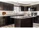Stylish kitchen featuring dark wood cabinetry, an island, and stainless steel appliances, perfect for cooking at 1221 Danielle Rd, Lebanon, IN 46052