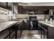 Well-lit kitchen featuring modern appliances, dark cabinetry, and sleek countertops at 1221 Danielle Rd, Lebanon, IN 46052