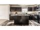 Modern kitchen with dark wood cabinets, a center island, granite countertops, and stainless steel appliances at 1221 Danielle Rd, Lebanon, IN 46052