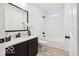 Bright bathroom featuring a dark vanity, granite countertop, and a shower-tub combination at 1303 N 8Th St, Elwood, IN 46036