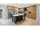A spacious kitchen featuring custom cabinets, stainless steel appliances, and a center island with seating at 1303 N 8Th St, Elwood, IN 46036