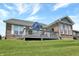 Backyard exterior showcasing deck, brick facade and expansive lawn at 1401 Blackthorne N Trl, Plainfield, IN 46168