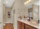 Bathroom featuring double sinks, granite countertops, wood cabinets and modern fixtures at 1401 Blackthorne N Trl, Plainfield, IN 46168