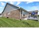 Home exterior showcasing brick facade, well-maintained lawn, and a deck at 1401 Blackthorne N Trl, Plainfield, IN 46168