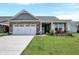 Charming brick home featuring a two-car garage and a welcoming front porch at 1401 Blackthorne N Trl, Plainfield, IN 46168
