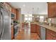 Kitchen with stainless steel appliances, wood cabinets and view of the dining area at 1401 Blackthorne N Trl, Plainfield, IN 46168