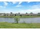 Scenic view of the community pond with lush greenery and well-maintained homes at 1401 Blackthorne N Trl, Plainfield, IN 46168