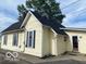 The back exterior elevation of the two story home features yellow siding and a dark shingled roof at 1440 E Morgan E St, Martinsville, IN 46151