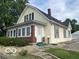 Charming two-story home with a brick foundation, yellow siding, and a well-maintained front yard at 1440 E Morgan E St, Martinsville, IN 46151