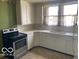 Traditional kitchen featuring white cabinets, linoleum flooring, and stainless steel appliances at 1440 E Morgan E St, Martinsville, IN 46151