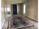 Cozy living room with neutral-toned walls, carpeted floor, built in cabinet, and natural light at 1440 E Morgan E St, Martinsville, IN 46151