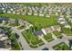 Panoramic aerial view of the community featuring lush green spaces and a serene pond at 1454 Woodfield Dr, Greenwood, IN 46143