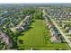 Wide aerial view of the neighborhood featuring green spaces and playground at 1454 Woodfield Dr, Greenwood, IN 46143