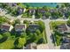 Aerial view of the neighborhood with lush landscaping, mature trees, and a nearby pond at 1454 Woodfield Dr, Greenwood, IN 46143
