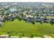Beautiful aerial view of the community, showcasing green space and a playground at 1454 Woodfield Dr, Greenwood, IN 46143